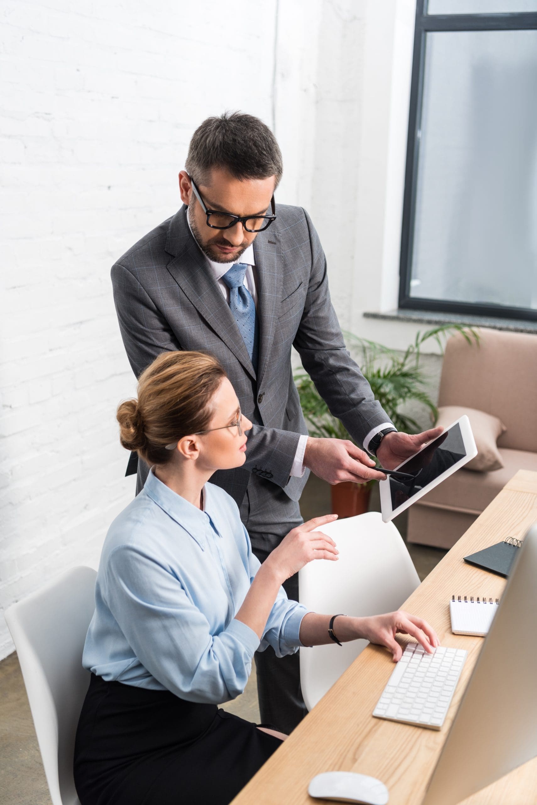 high angle view of businesspeople working together with tablet at office