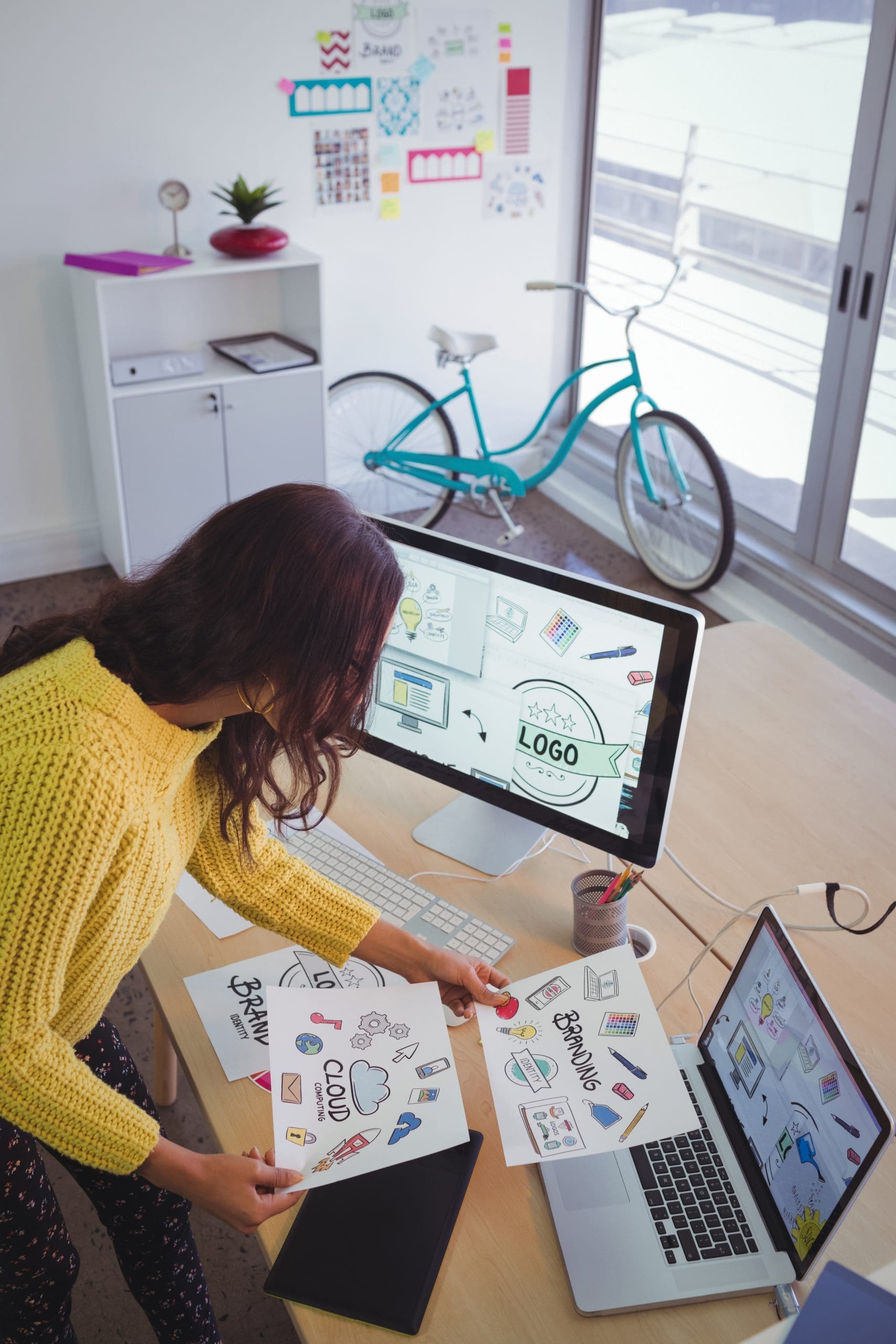 High angle view of female graphic designer working at office desk